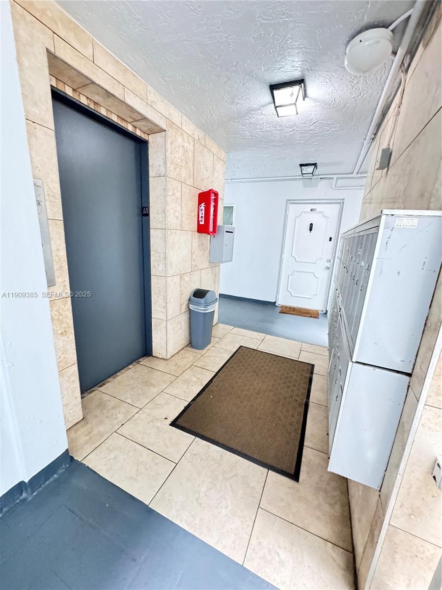 9441 Evergreen Place, Unit 206 Davie, FL 33324 - Photo 7 of 11 a workspace with furniture and wooden floor