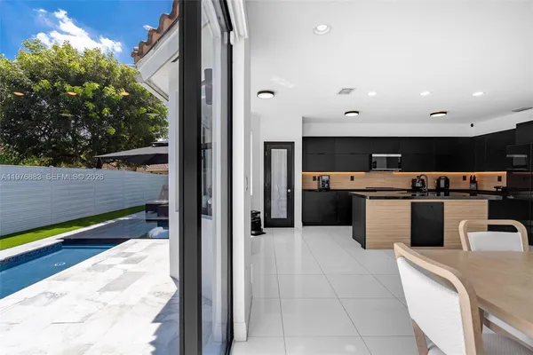 a kitchen with stainless steel appliances kitchen island granite countertop a stove and a sink