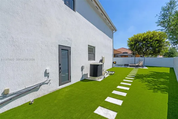 a living room with furniture and large windows