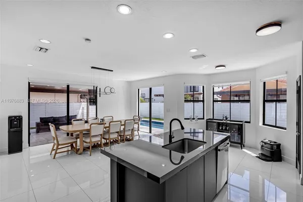 an aerial view of residential houses with outdoor space and swimming pool