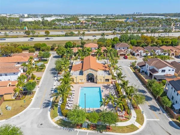 an aerial view of residential houses with outdoor space and river