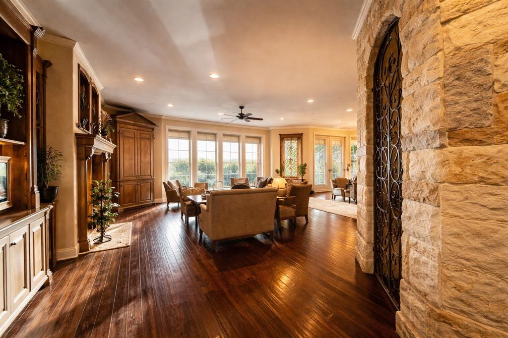 1919 Kings Pass Heath, TX 75032 - Photo 17 of 38 Spacious living area featuring polished wood floors, a decorative built-in wooden cabinet, and recessed lighting
