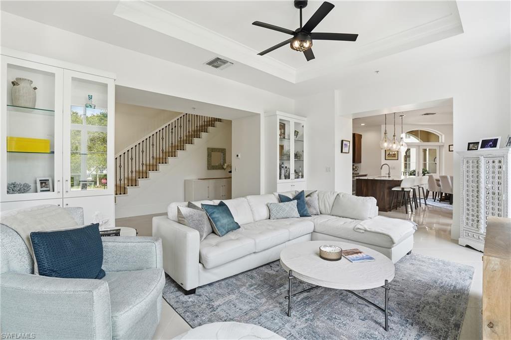 1008 7th Street South, Unit B1 Naples, FL 34102 - Photo 13 of 48 Living area featuring suspended lighting, ceiling fan, and a raised ceiling