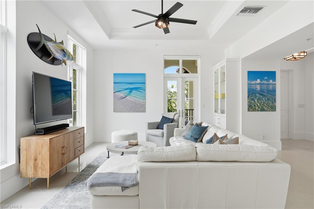 1008 7th Street South, Unit B1 Naples, FL 34102 - Photo 14 of 48 Living room with ceiling fan, light tile patterned flooring, and crown molding