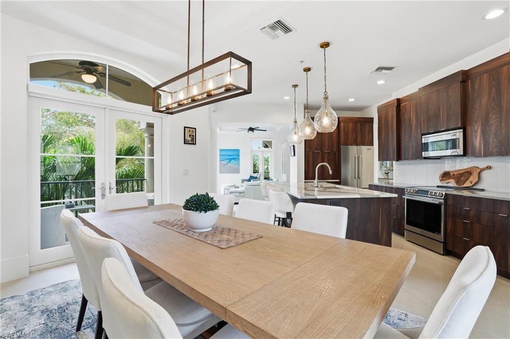 1008 7th Street South, Unit B1 Naples, FL 34102 - Photo 20 of 48 Dining room with ceiling fan, french doors, light tile patterned flooring, and recessed lighting