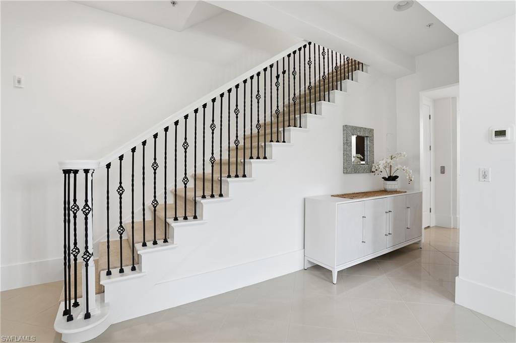 1008 7th Street South, Unit B1 Naples, FL 34102 - Photo 22 of 48 Stairway featuring tile patterned flooring