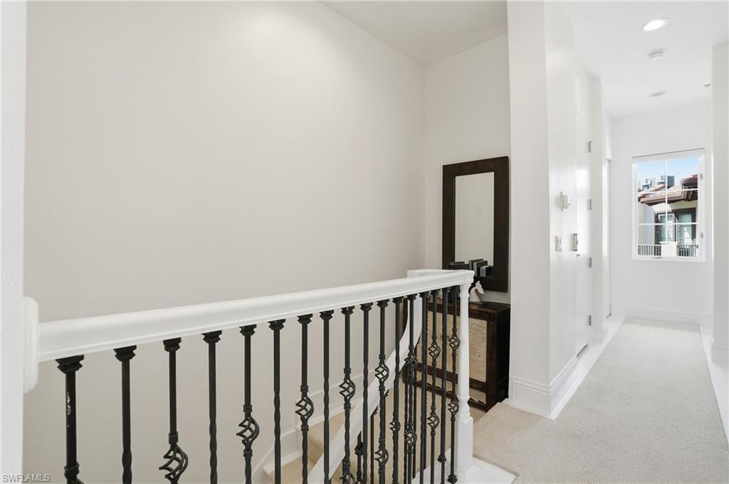 1008 7th Street South, Unit B1 Naples, FL 34102 - Photo 23 of 48 Hallway with light colored carpet and an upstairs landing