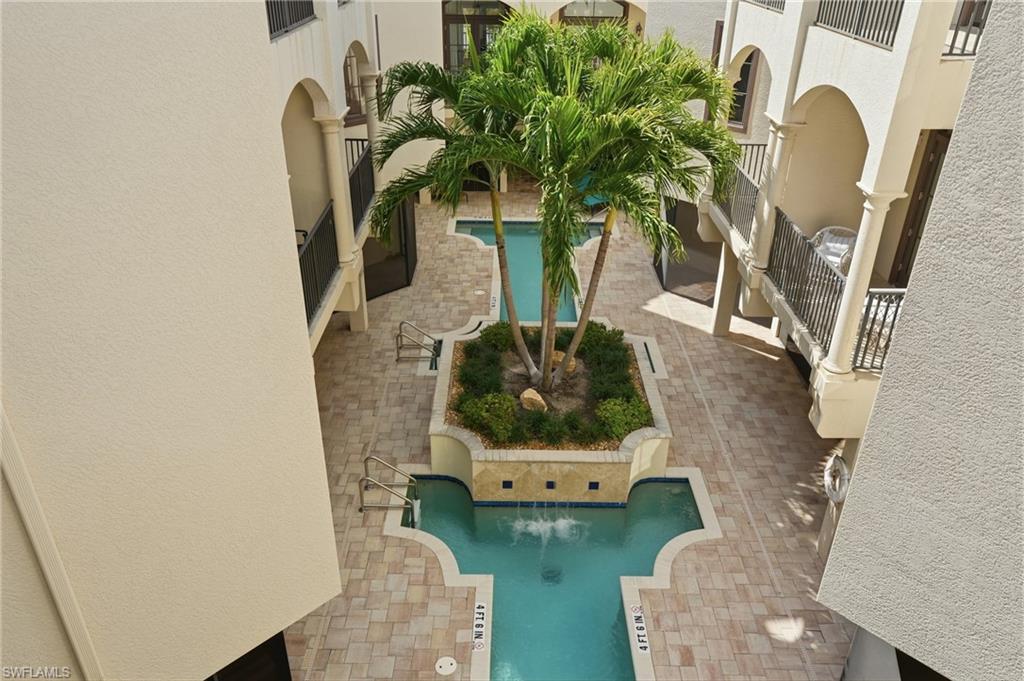 1008 7th Street South, Unit B1 Naples, FL 34102 - Photo 29 of 48 Community pool featuring a patio area and a balcony