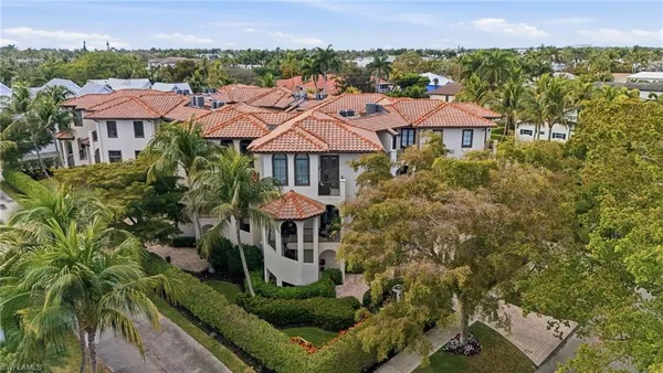 an aerial view of a house with yard and outdoor seating