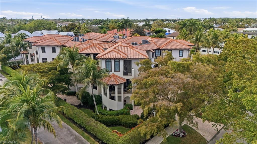 1008 7th Street South, Unit B1 Naples, FL 34102 - Photo 4 of 48 Aerial view of residential area with a tree filled landscape