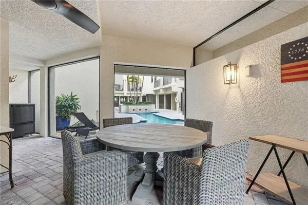 a view of kitchen with stainless steel appliances cabinets and windows