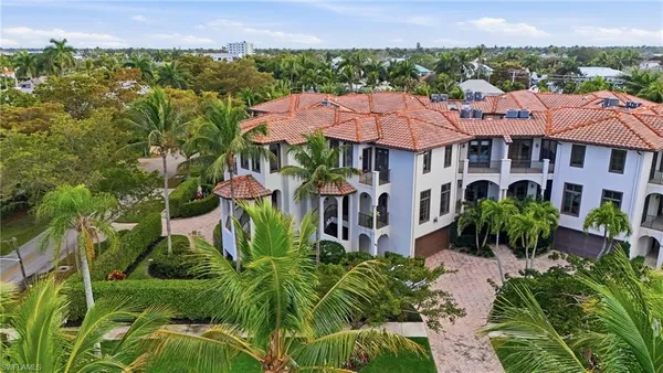 an aerial view of multiple houses with a yard