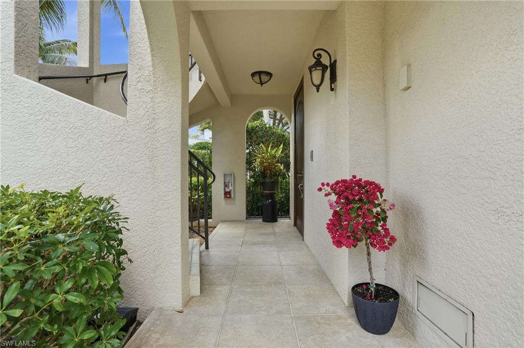 1008 7th Street South, Unit B1 Naples, FL 34102 - Photo 7 of 48 Entrance to property featuring stucco siding and a patio