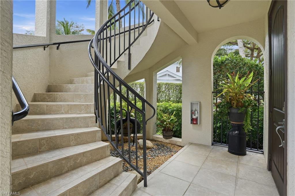 1008 7th Street South, Unit B1 Naples, FL 34102 - Photo 8 of 48 Entrance foyer featuring healthy amount of natural light, tile patterned flooring, and a textured wall