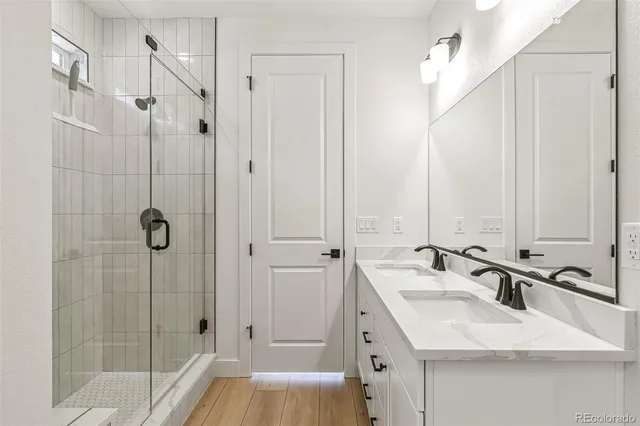 a bathroom with a double vanity sink and mirror