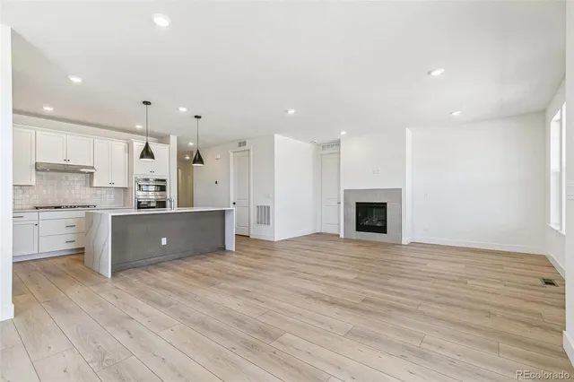 a open kitchen with kitchen island a sink stainless steel appliances and cabinets