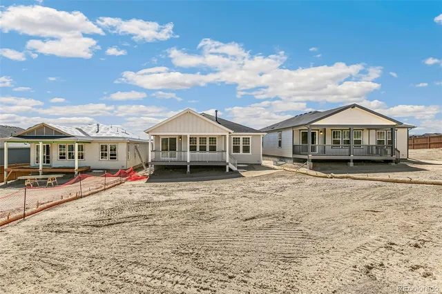 a view of a white house with a yard