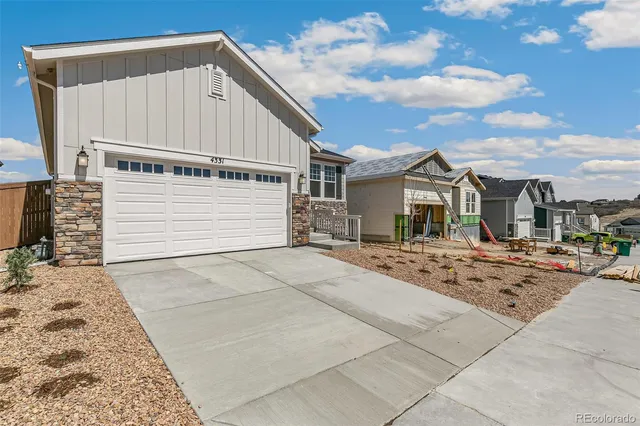 a view of a house with yard and sitting area