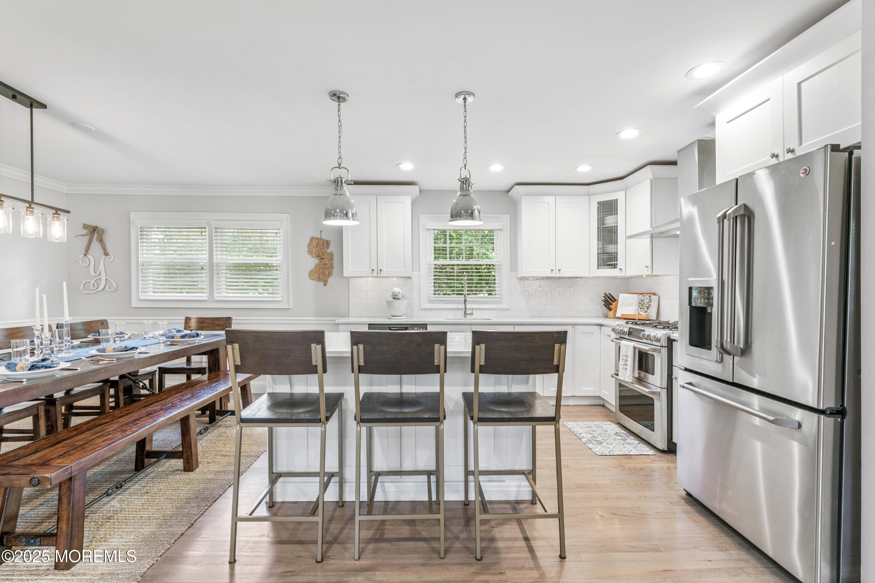 28 High Point Road Lincroft, NJ 07738 - Photo 12 of 42 a kitchen with stainless steel appliances granite countertop a stove a refrigerator a kitchen island a dining table and chairs