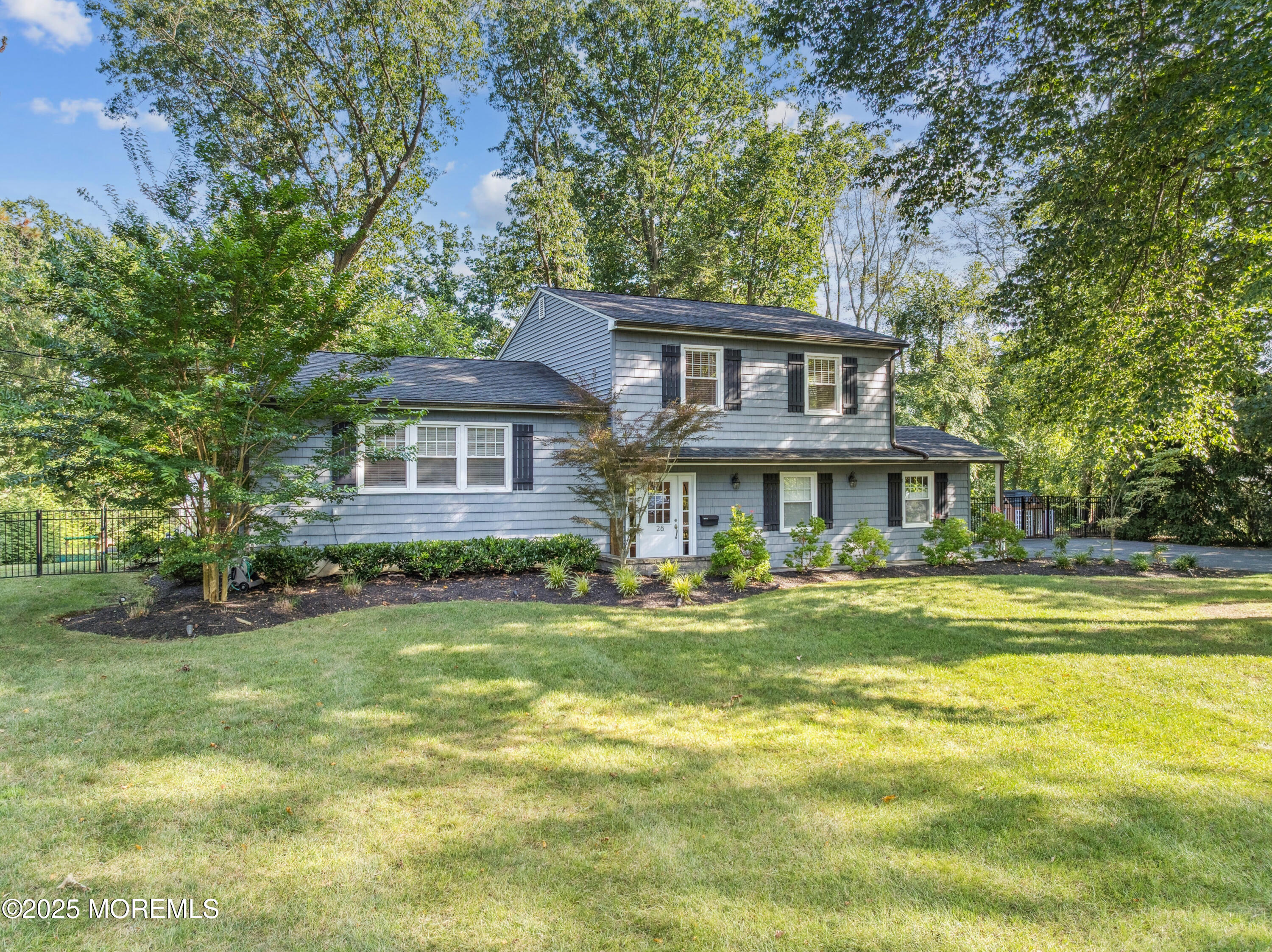 28 High Point Road Lincroft, NJ 07738 - Photo 2 of 42 a front view of a house with a garden
