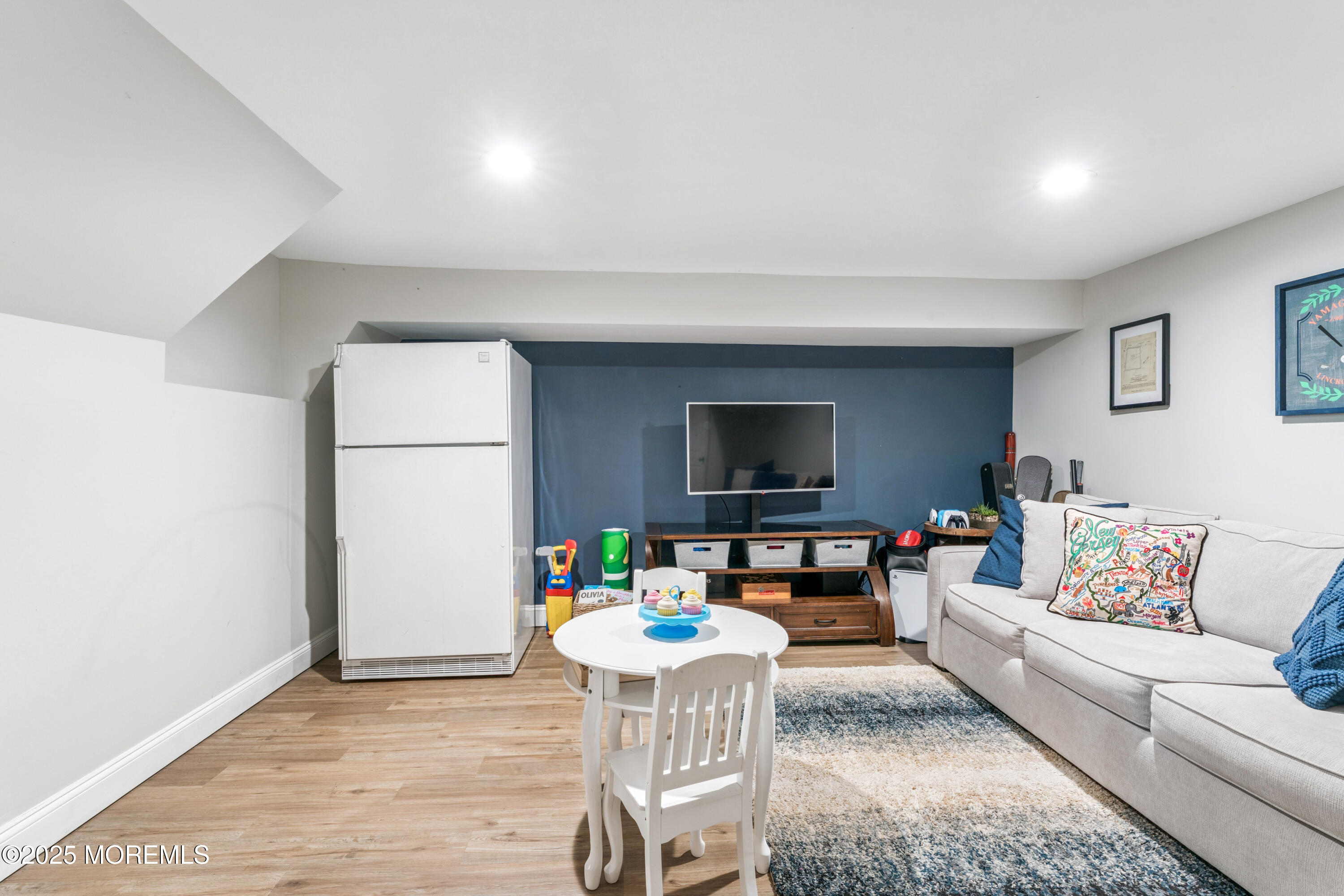 28 High Point Road Lincroft, NJ 07738 - Photo 27 of 42 a living room with furniture and a flat screen tv