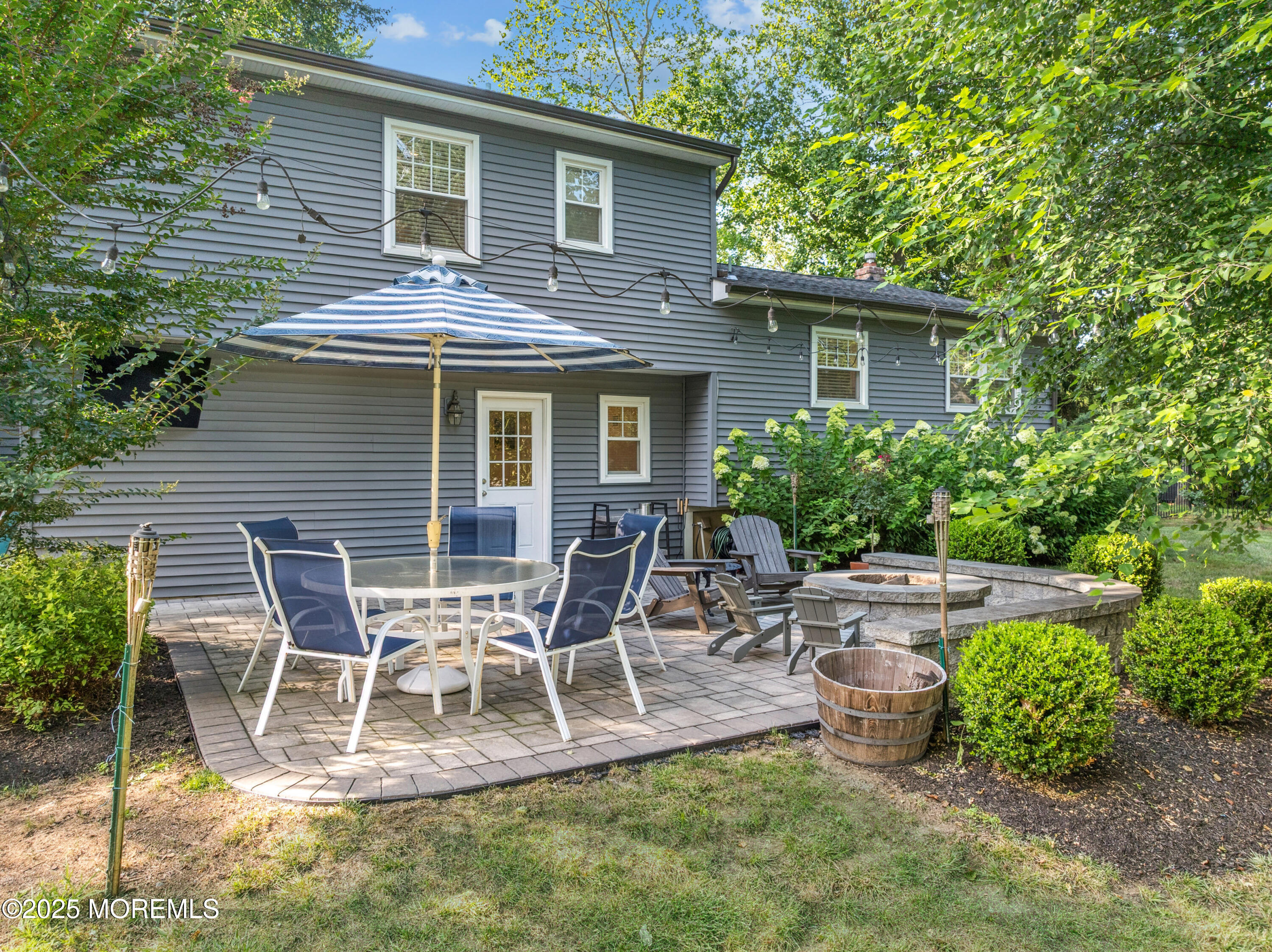 28 High Point Road Lincroft, NJ 07738 - Photo 31 of 42 a view of a backyard with table and chairs and potted plants