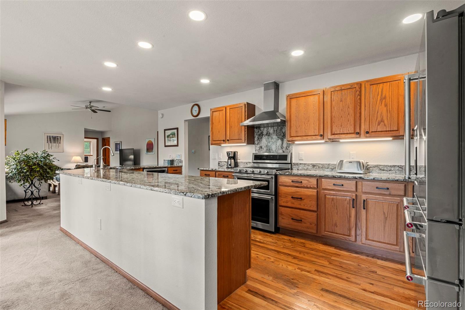 84 Marys Lane Bailey, CO 80421 - Photo 6 of 35 a kitchen with stainless steel appliances granite countertop a stove top oven a sink dishwasher and a refrigerator with wooden floor