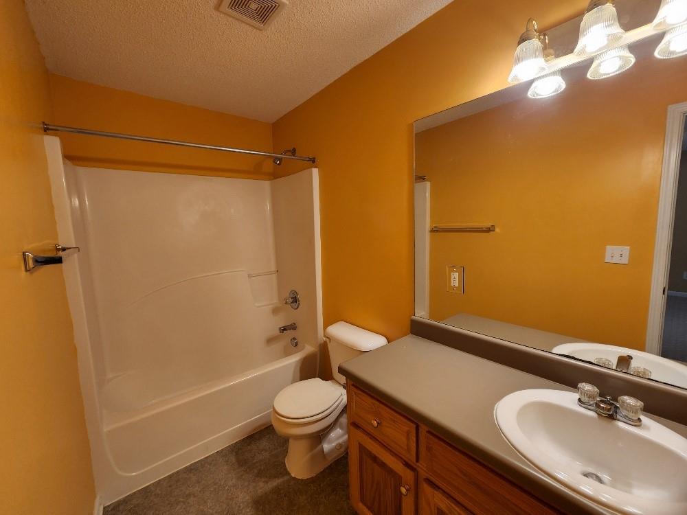 663 Elliott Drive Northwest Rome, GA 30165 - Photo 5 of 9 a bathroom with a sink a toilet and shower