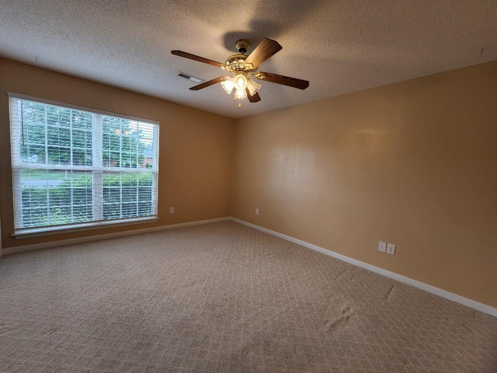 663 Elliott Drive Northwest Rome, GA 30165 - Photo 6 of 9 a view of an empty room with chandelier fan and fire place