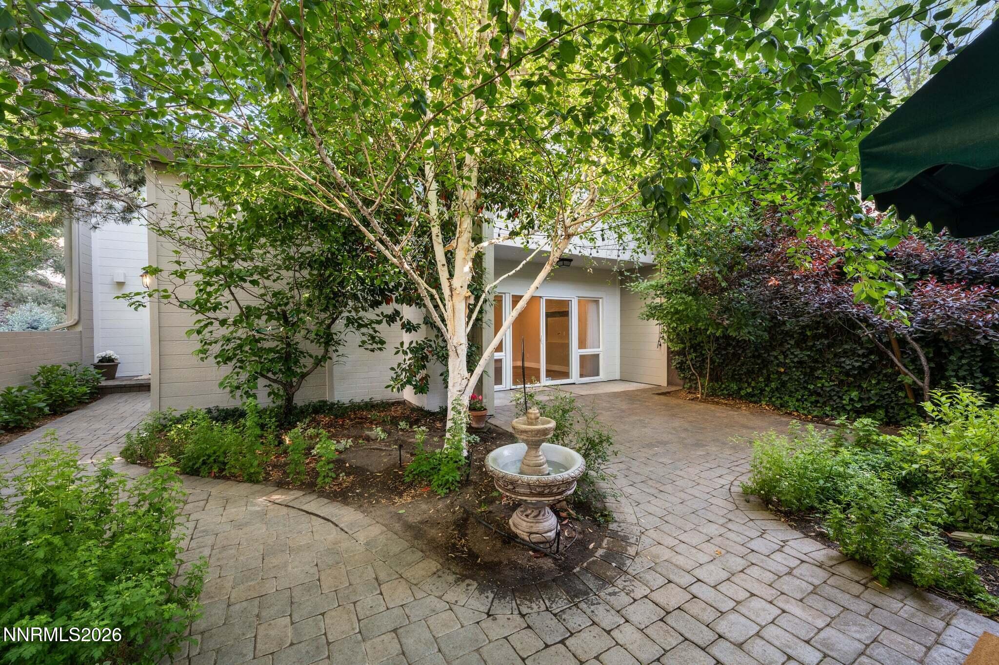430 Angela Place Reno, NV 89509 - Photo 4 of 48 a view of a backyard with table and chairs and a lots of flower plants