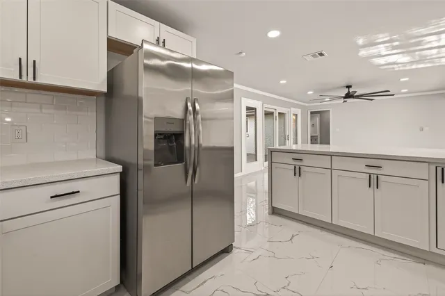 a bedroom with a bed a desk and chair with window