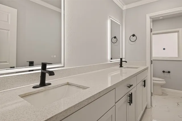 a bedroom with a bed and ceiling fan