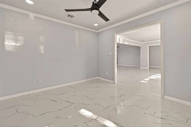 a view of a big room with wooden floor and windows