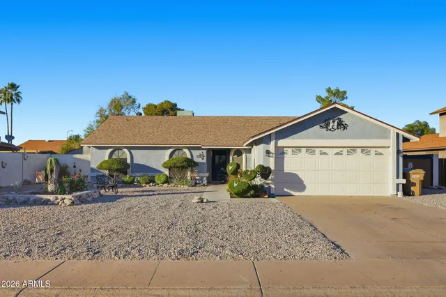 a view of a house with a yard and garage