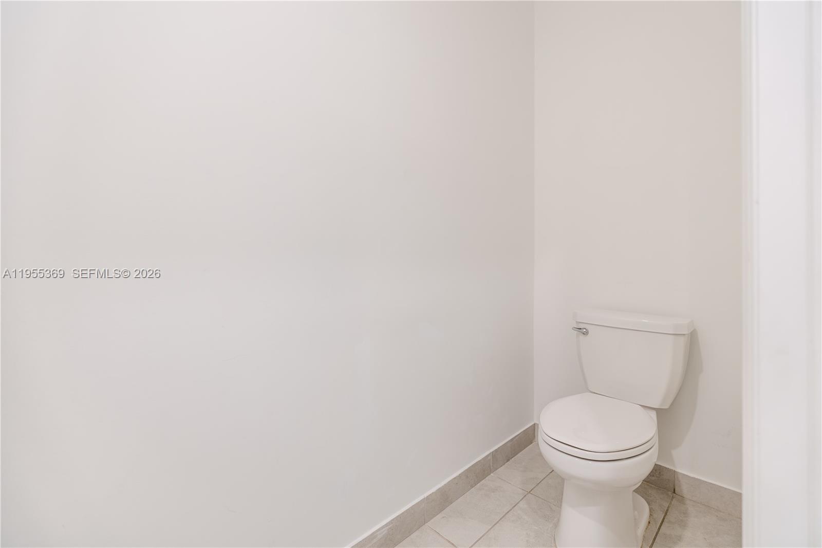 24671 Southwest 119th Place Homestead, FL 33032 - Photo 16 of 31 a white toilet sitting next to a white wall
