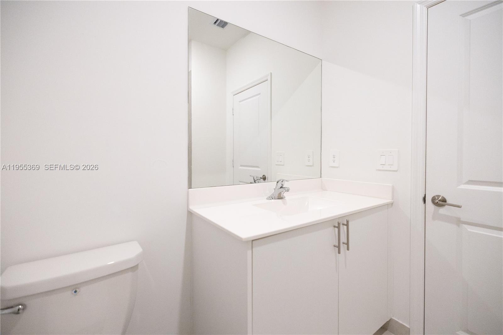 24671 Southwest 119th Place Homestead, FL 33032 - Photo 20 of 31 a bathroom with a sink a toilet and a mirror