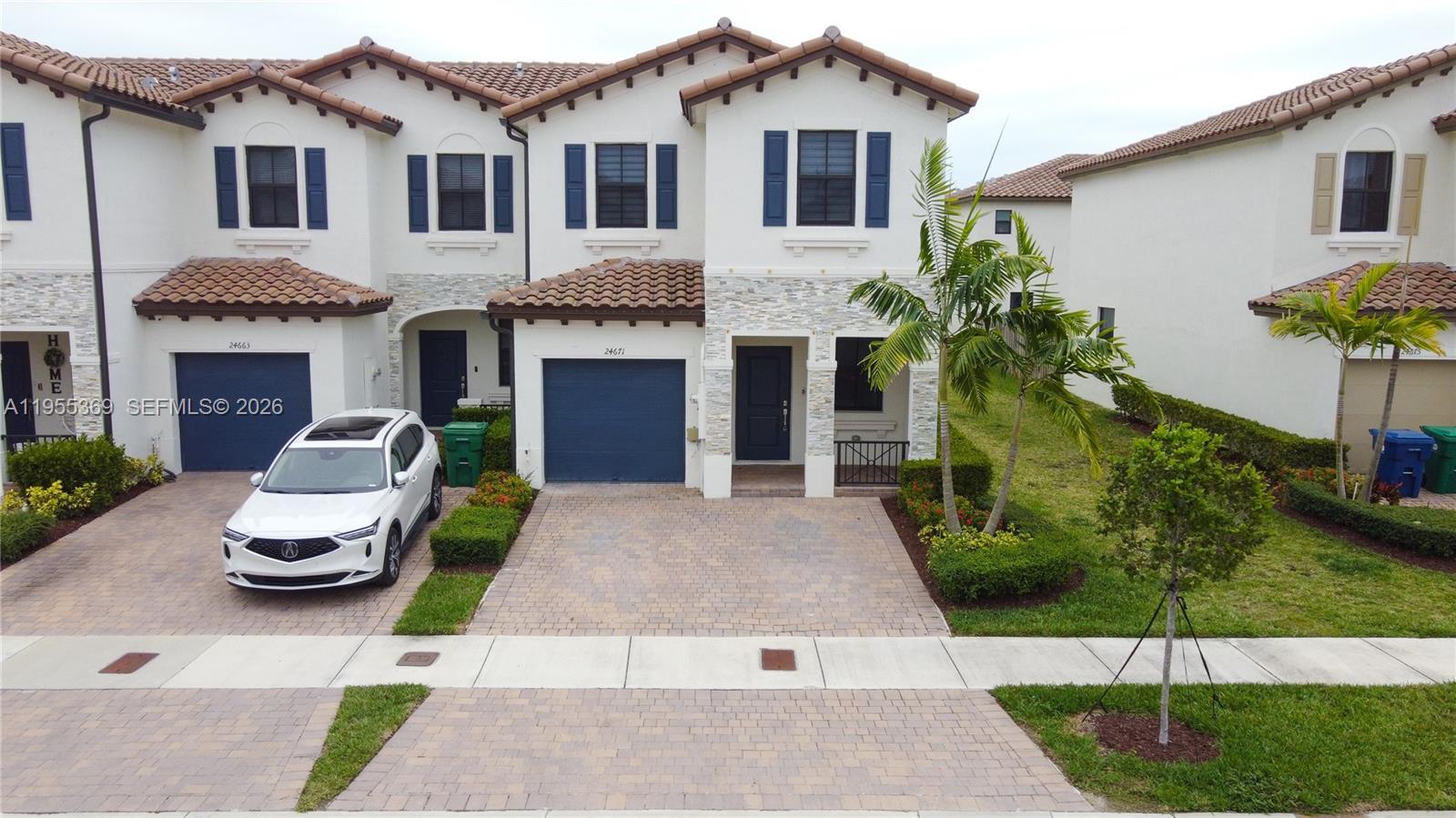 24671 Southwest 119th Place Homestead, FL 33032 - Photo 2 of 31 a front view of a house with a garden and plants