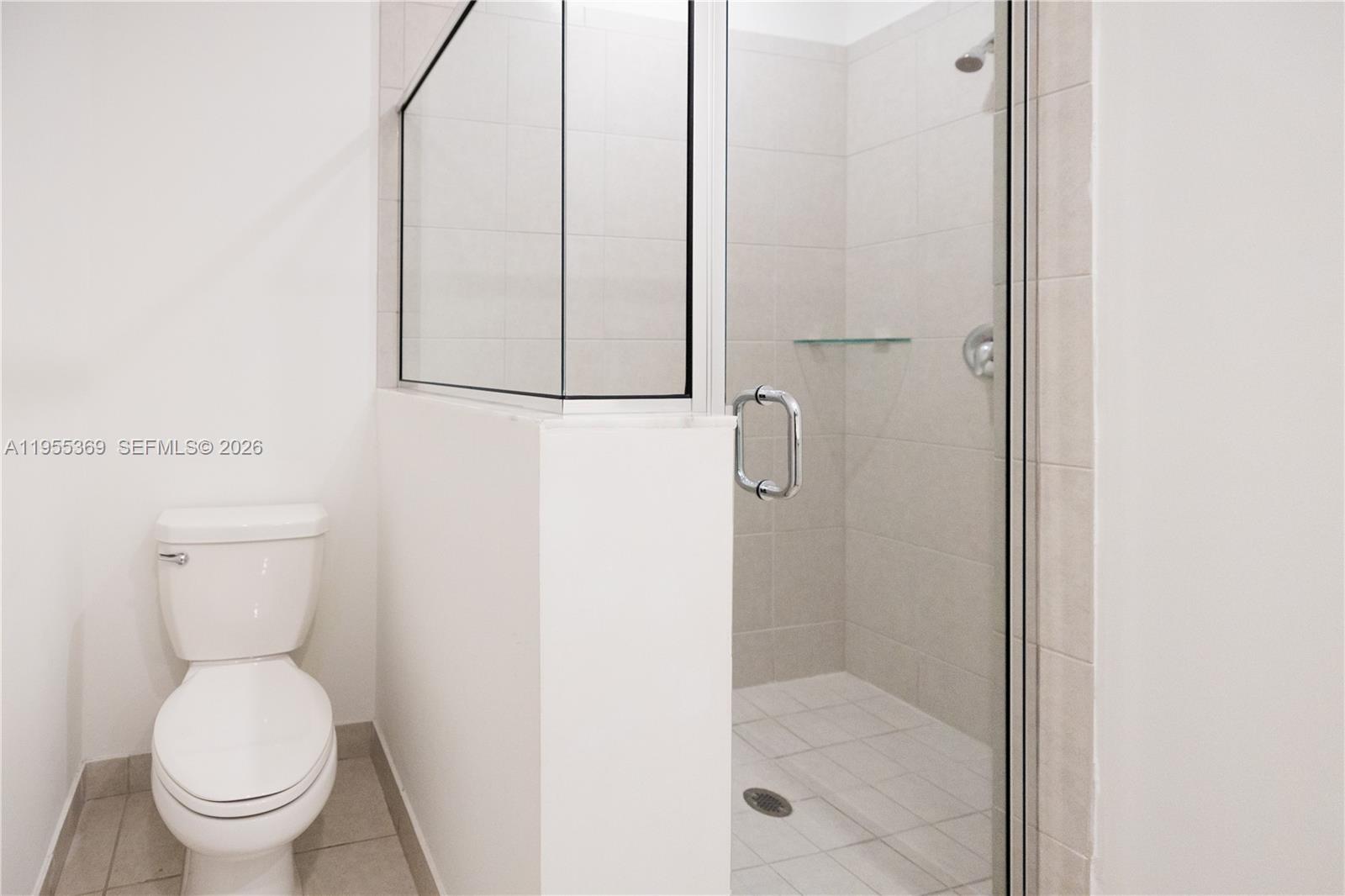 24671 Southwest 119th Place Homestead, FL 33032 - Photo 30 of 31 a bathroom with a granite countertop toilet and a shower