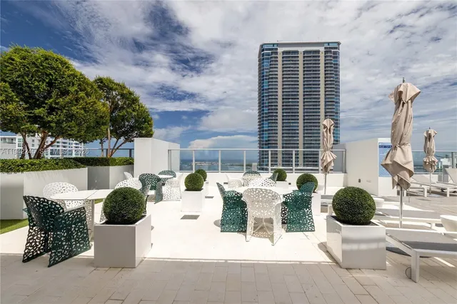 a view of a patio with couches and potted plants