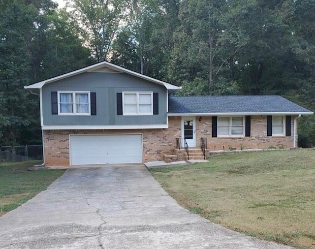 4775 Cold Creek Way Southeast Conyers, GA 30094 - Photo 1 of 1 a front view of house with yard and trees in the background