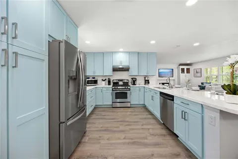 a large kitchen with cabinets and stainless steel appliances