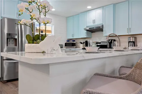 a kitchen with stainless steel appliances granite countertop a sink a stove and a refrigerator