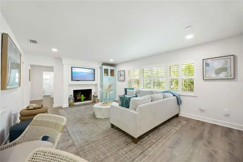 a living room with furniture fireplace and a window