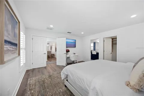 a spacious bedroom with a bed and a large window