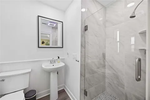 a bathroom with a sink mirror and toilet