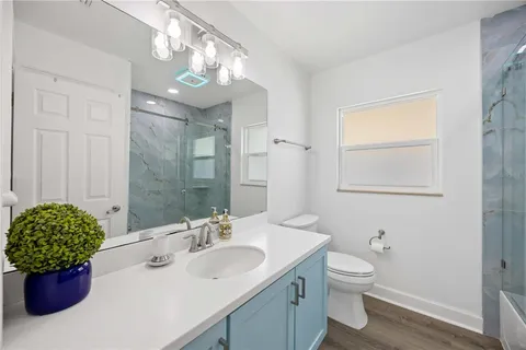 a bathroom with a sink a toilet and mirror