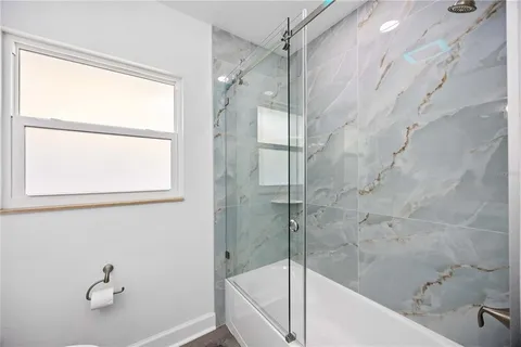 a bathroom with a bathtub and a shower