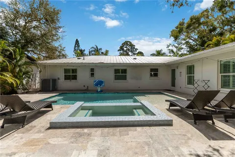 a view of a white house with a patio