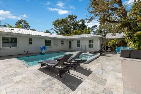 a roof deck with table and chairs under an umbrella