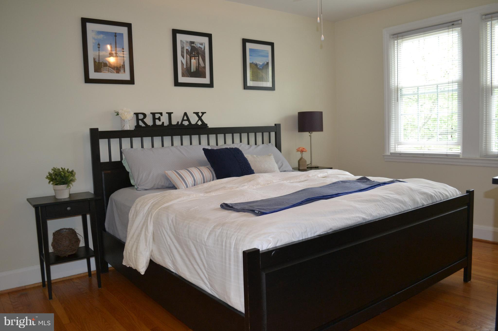 412 Overbrook Road Baltimore, MD 21212 - Photo 14 of 26 a bedroom with a bed and wooden floor